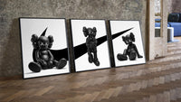 KAWS x Nike Monochrome Companion framed poster set of 3 three-piece set leaning on parquet beside a vintage loft door