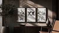 KAWS XX Outline Sketch triptych in three walnut frames above a sideboard in a warm room