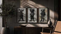KAWS Nike Street triptych in three walnut frames above a sideboard in a warm room