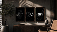 KAWS Companion XX Nike framed poster set of 3 triptych in three walnut frames above a sideboard in a warm room