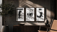 KAWS Black & White Classics triptych in three walnut frames above a sideboard in a warm room