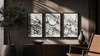 KAWS XX Crosshatch triptych in three walnut frames above a sideboard in a warm room