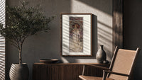 Mucha La Trappistine poster framed above a fluted sideboard beside a potted tree