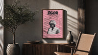 Pink Tyler, the Creator IGOR Tracklist poster framed above a fluted sideboard beside a potted tree