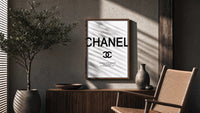 Coco Chanel Quote Typography poster framed above a fluted sideboard beside a potted tree