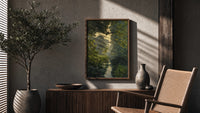 forest pond framed by overhanging branches vintage art print poster framed above a fluted sideboard beside an olive tree