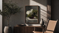 white peony in dark glass vase vintage art print poster framed above a fluted sideboard beside an olive tree
