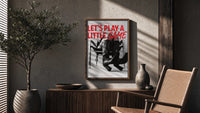 Let's Play a Little Game poster framed above a fluted sideboard beside a potted tree