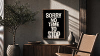 Sorry No Time To Stop poster framed above a fluted sideboard beside a potted tree