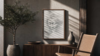 female face portrait study vintage art print poster framed above a fluted sideboard beside an olive tree