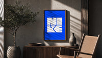 Nike Blue Typographic Logo poster framed above a fluted sideboard beside a potted tree