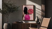 Black Woman Holding Pink Roses poster framed above a fluted sideboard beside a potted tree