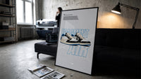 Travis Scott x Fragment Air Jordan 1 framed poster print in a slim black frame leaning on a dark sofa in a concrete print…