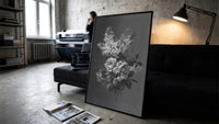 white lilac and roses bouquet vintage art print print in a slim black frame leaning on a dark sofa in a concrete print studio