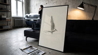 tern in flight sketch vintage art print print in a slim black frame leaning on a dark sofa in a concrete print studio