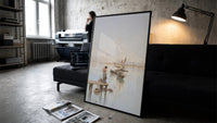 woman and dog on a dock watching sailboats vintage art print print in a slim black frame leaning on a dark sofa in a…
