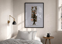 Kendrick Lamar DAMN Collage print in a black frame above a bed with striped linens, a brass wall lamp and a sunlit window
