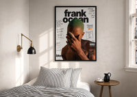 Frank Ocean Blonde Annotated Album Cover print in a black frame above a bed with striped linens