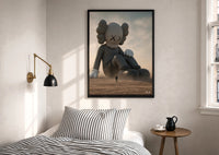 KAWS Companion Desert Monochrome Streetwear print in a black frame above a bed with striped linens