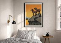 WPA Parks Preserve Wild Life print in a black frame above a bed with striped linens, a brass wall lamp and a sunlit window