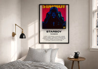 The Weeknd Starboy Album Cover print in a black frame above a bed with striped linens, a brass wall lamp and a sunlit window