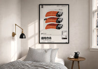 SEAxFOOD Market Salmon Sushi Lighter print in a black frame above a bed with striped linens