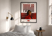 The Weeknd Popular Idol Magazine Cover print in a black frame above a bed with striped linens