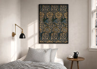 William Morris Kennet print in a black frame above a bed with striped linens, a brass wall lamp and a sunlit window