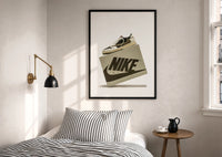 Air Jordan 1 Travis Scott Olive Sneaker print in a black frame above a bed with striped linens