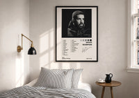 Drake Scorpion Album Tracklist print in a black frame above a bed with striped linens, a brass wall lamp and a sunlit window