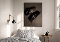 Air Jordan 1 x Travis Scott Velvet Brown Mocha print in a black frame above a bed with striped linens