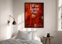 Off the Beaten Path KAWS-Inspired Red Plush print in a black frame above a bed with striped linens