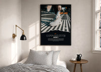 White Off-White Nike Air Force 1 print in a black frame above a bed with striped linens
