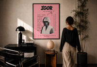 Pink Tyler, the Creator IGOR Tracklist print in a black frame on a sunlit wall with a viewer