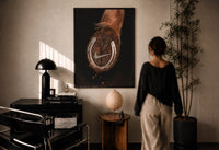 Nike Horse Hoof Swoosh Equestrian print in a black frame on a sunlit plaster wall, a person looking on beside a mushroom lamp