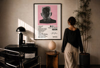 Tyler, The Creator IGOR Tracklist print in a black frame on a sunlit plaster wall, a person looking on beside a mushroom lamp
