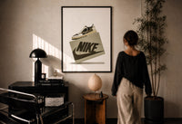 Air Jordan 1 Travis Scott Olive Sneaker print in a black frame on a sunlit wall with a viewer
