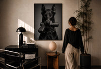 Doberman Pistol Spiked Collar print in a black frame on a sunlit plaster wall, a person looking on beside a mushroom lamp