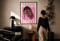 Travis Scott Cactus Jack Portrait print in a black frame on a sunlit plaster wall, a person looking on beside a mushroom lamp