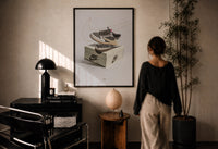 Air Jordan 1 Travis Scott Reverse Mocha print in a black frame on a sunlit wall with a viewer