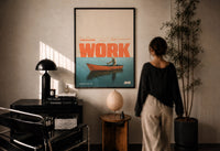 Slow Day at Work Gone Fishing print in a black frame on a sunlit plaster wall, a person looking on beside a mushroom lamp