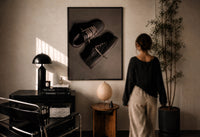 Air Jordan 1 x Travis Scott Velvet Brown Mocha print in a black frame on a sunlit wall with a viewer