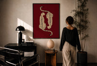Mirrored Cheetahs print in a black frame on a sunlit plaster wall, a person looking on beside a mushroom lamp