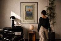 Splendor Solis The Sun print in a black frame on a sunlit plaster wall, a woman looking on beside a mushroom lamp