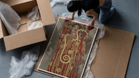 Klimt's Hygieia with gold serpent vintage art print framed print being unpacked from protective bubble wrap and a box