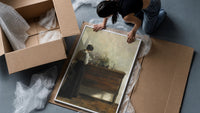 woman reading at a dresser in a quiet interior vintage art print framed print being unpacked from protective bubble wrap…
