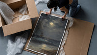tall ship at sea under full moon vintage art print framed print being unpacked from protective bubble wrap and a box