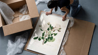 white Provence rose botanical study vintage art print framed print being unpacked from protective bubble wrap and a box