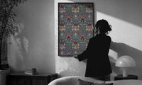 William Morris Snakeshead print in a slim black frame being hung on a sunlit wall in a monochrome room