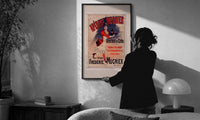 Aperitif Mugnier Cafe print in a slim black frame being hung on a sunlit wall in a monochrome room